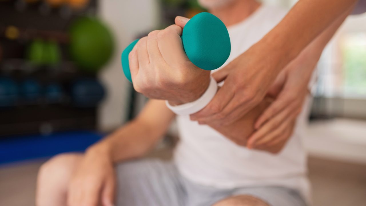 Close up picture of human hand with a dumbbell